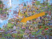 Zdjęcie przedstawia barwną mapę Europy. W poszczególnych krajach narysowane są obrazki pokazujące, z czego słynie dany kraj. Duża żółta strzałka wskazuje na Belgię. 